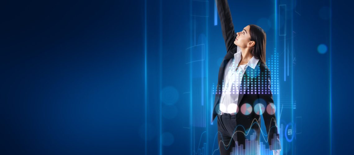 Attractive young european businesswoman surrounded with business chart hologram on blurry blue background with mock up place for your text or advertisement. Business boost up, success, future and start up concept