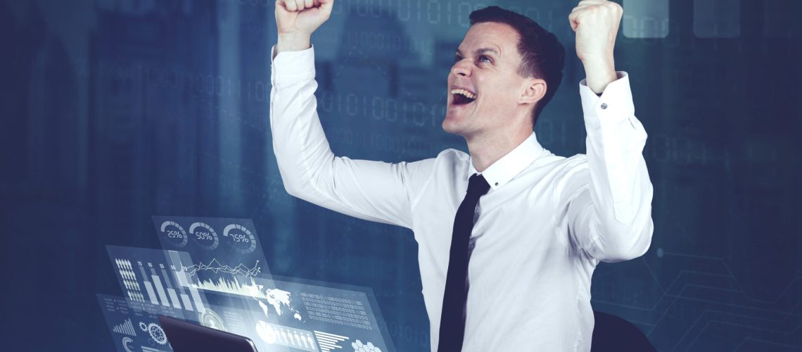 Happy businessman with futuristic business chart screens